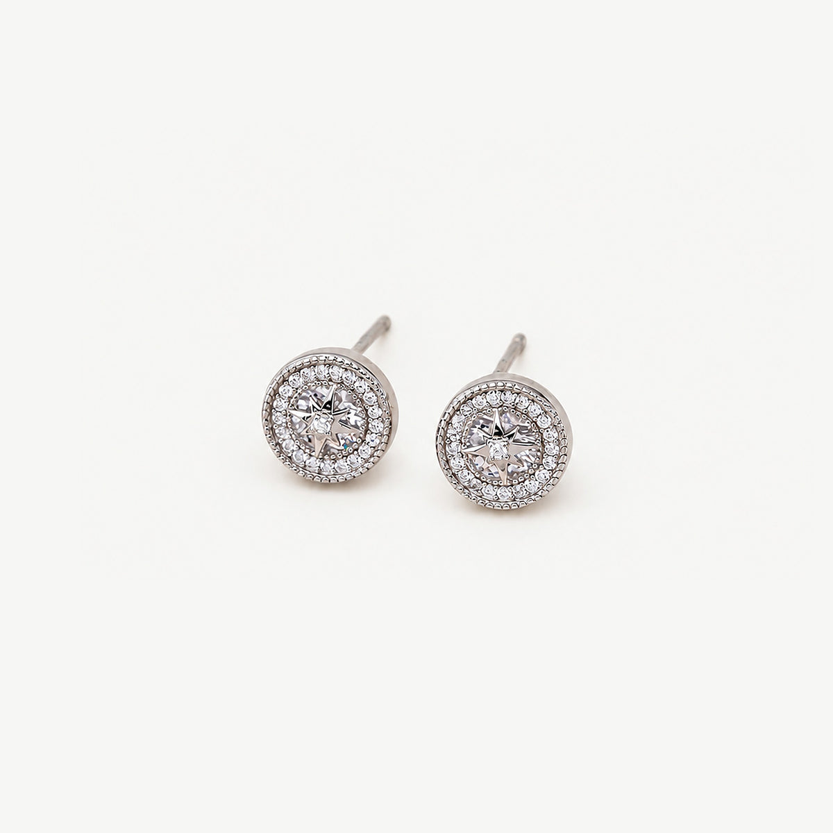 Pair of sterling silver starburst halo stud earrings, a ring of small clear stones framed by beaded milgrain edges
