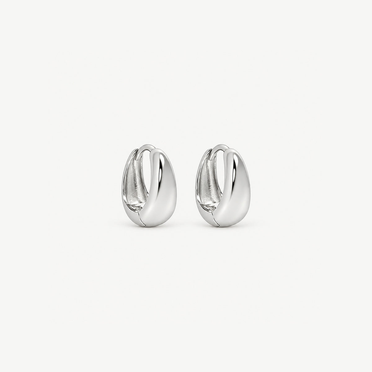 Pair of 8 mm sterling silver teardrop huggie hoops with white gold plating, standing upright on a plain ground