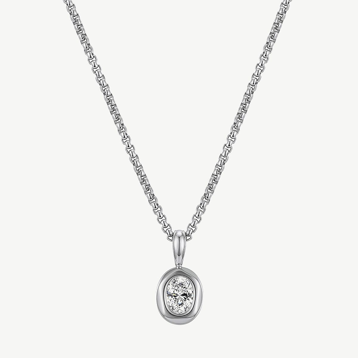Front view of a silver tone stainless steel oval pendant necklace hanging straight on a box chain, stone in a bezel
