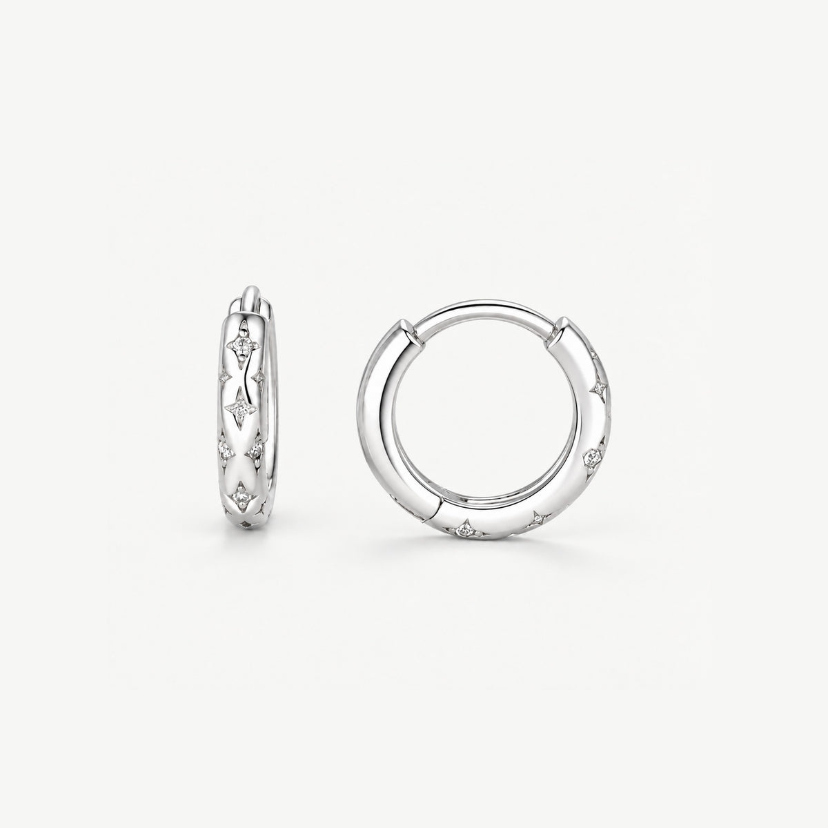 Sterling silver star hoop earring from the side and the front, engraved stars set with CZ along the band