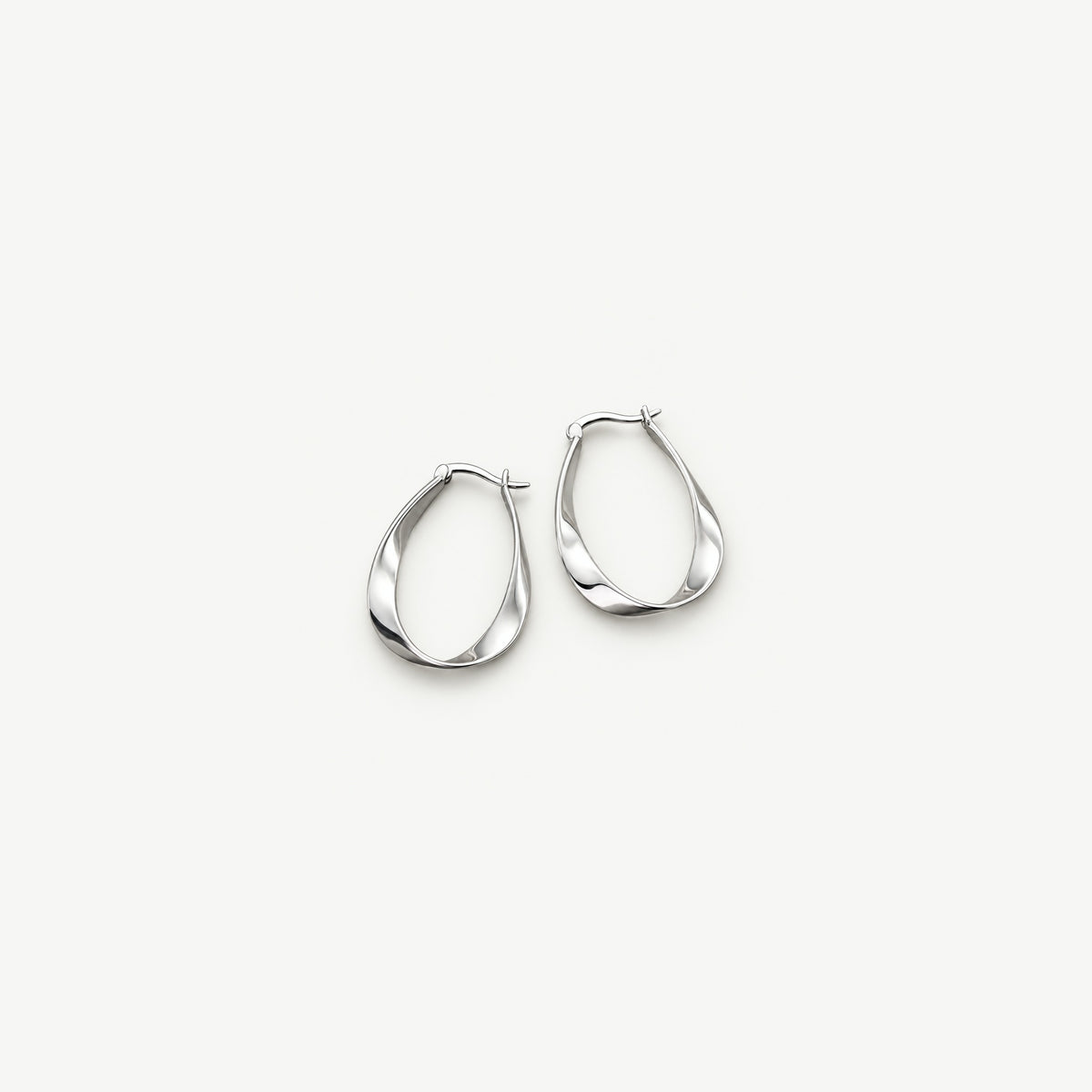 Pair of sterling silver twisted teardrop hoop earrings side by side, polished ribbon bands and latch tops in front view